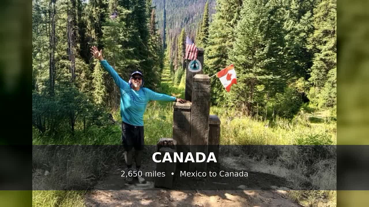 Martin Gatrost celebrating at the Pacific Crest Trail monument on the Canadian border
